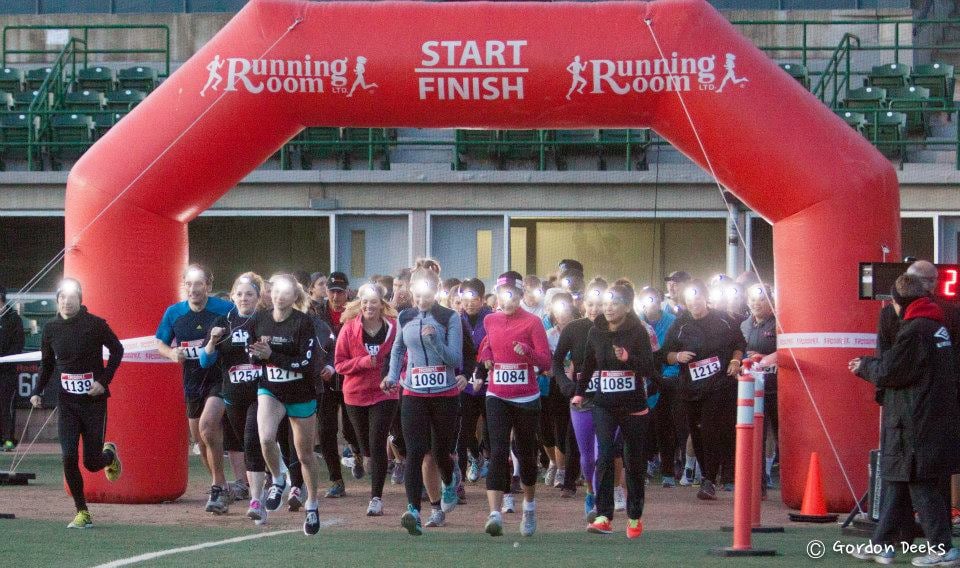 photo shows runners starting the sight night race wearing their headlamps