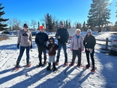 a group of participants of all ages, dressed in snow shoes and ready to explore the trail